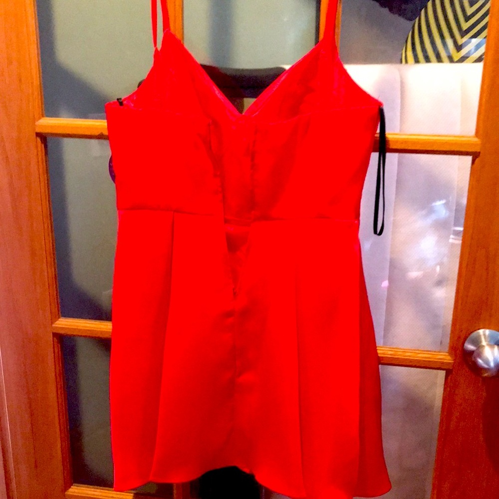 Red 100% Polyester mid thigh dress. With hidden side pockets. Perfect for Xmas.